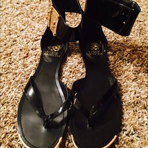 Black sandals with gold details and ankle cuff